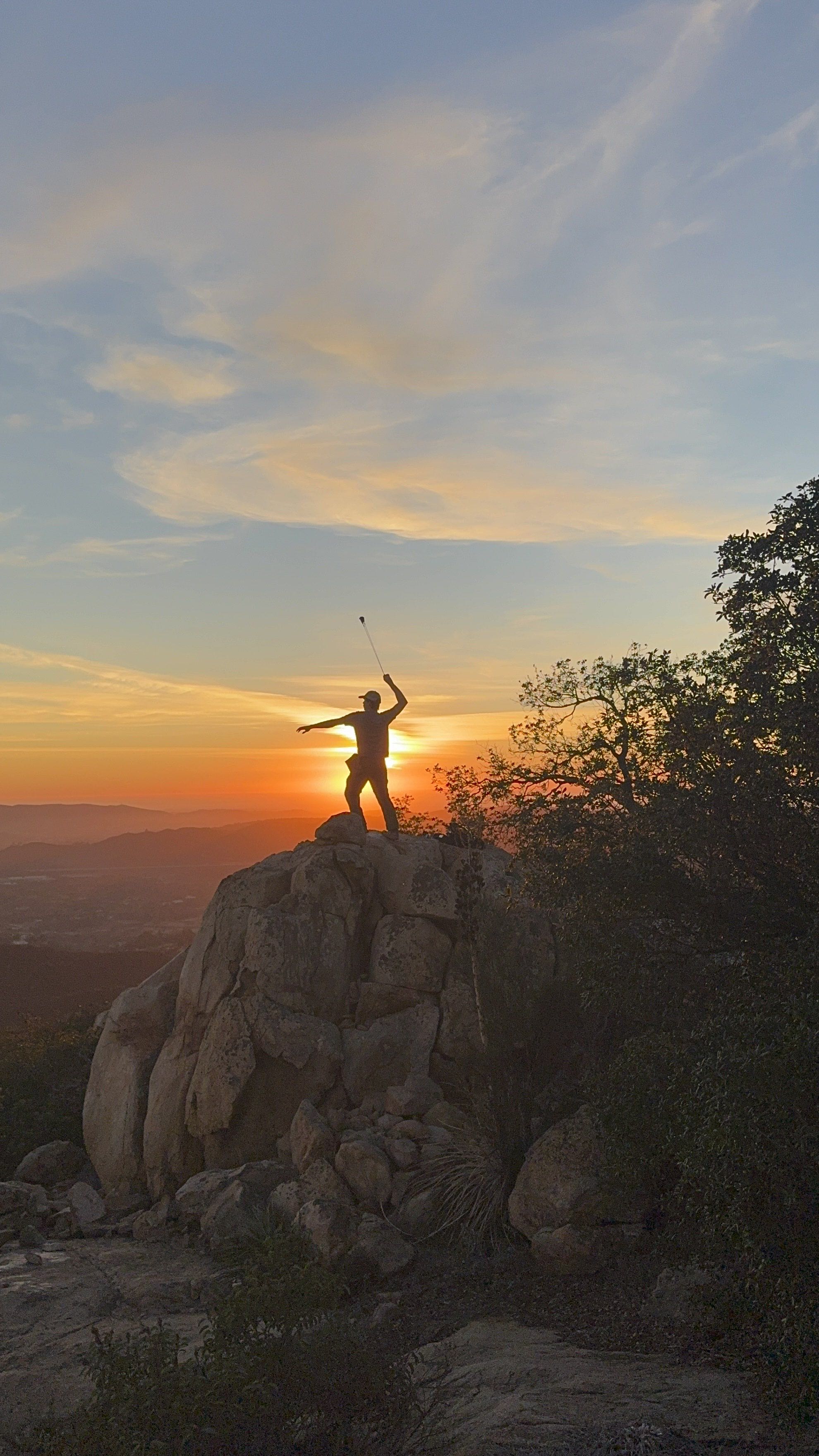 Man using shepherdsling in the sunset