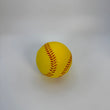 Yellow softball with red stitching on a white background