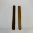 Two bronze-colored metal strips on a white background