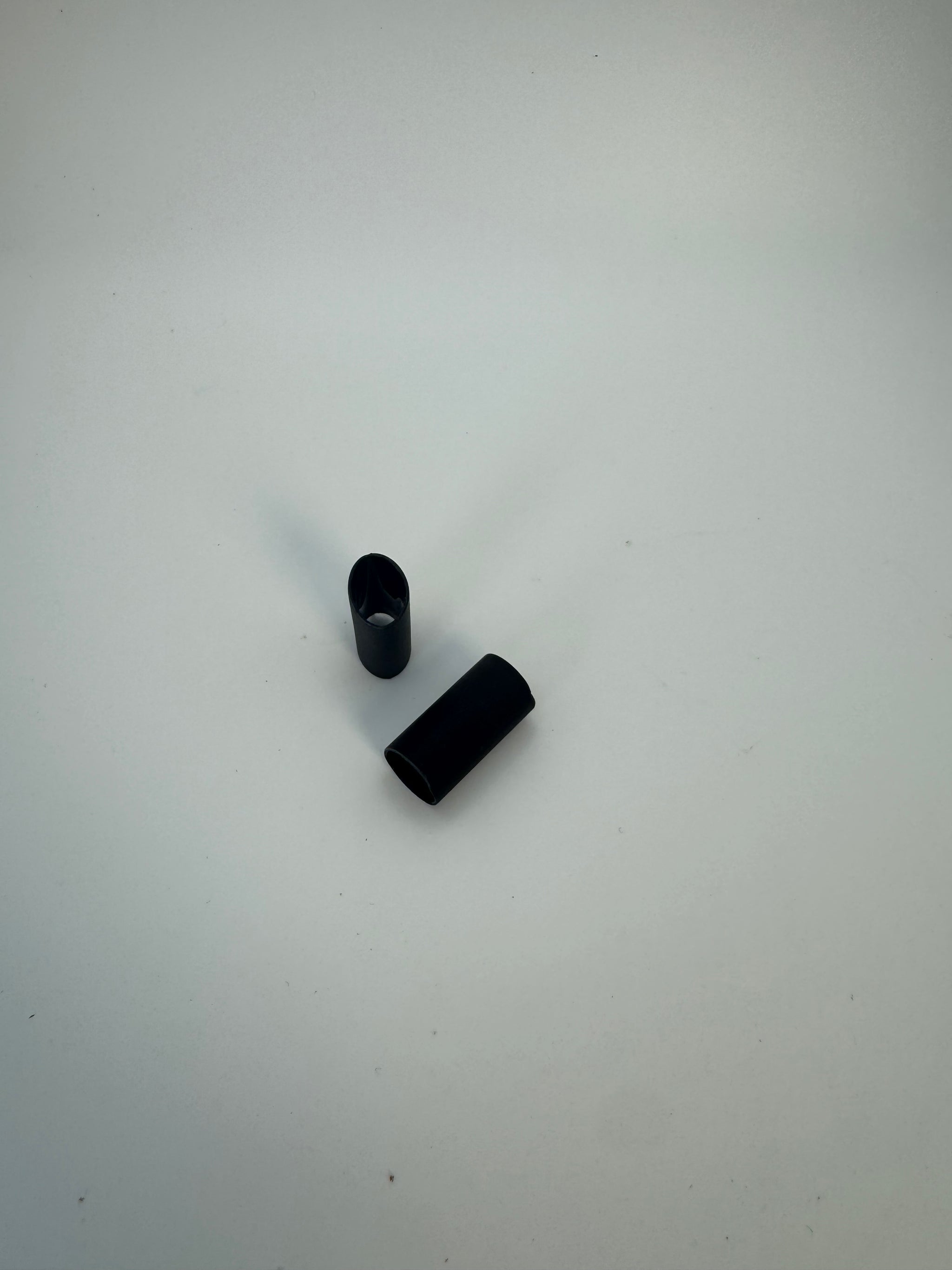 Two black objects on a white background